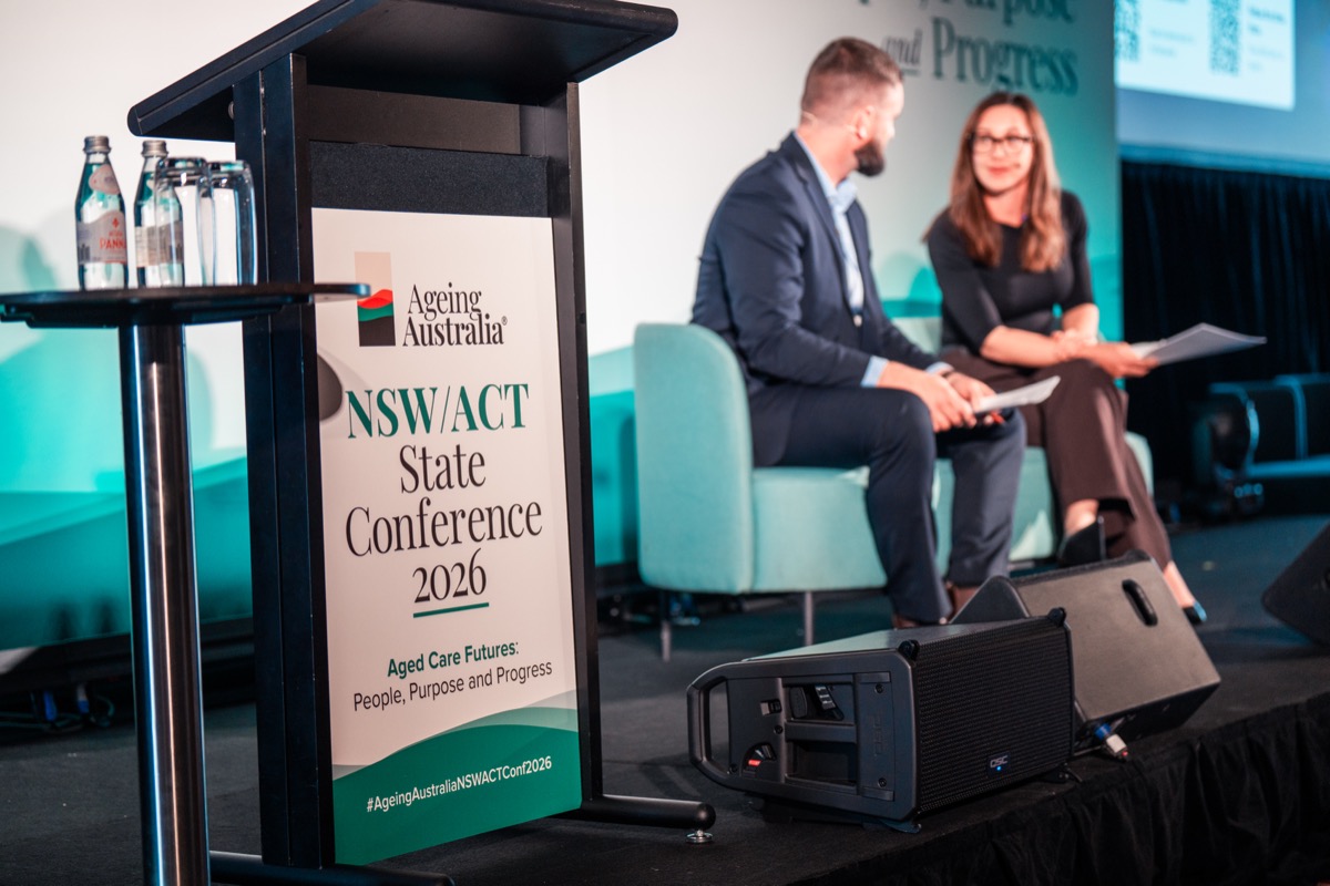 Dane Mitchell and Rose Plater on stage at a state aged care conference